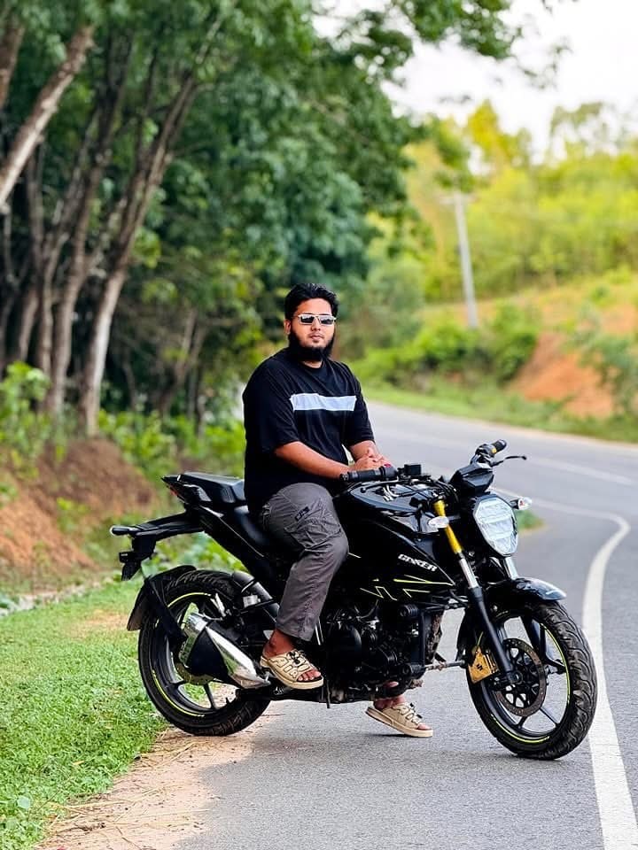 Satisfied Customer Wearing our Black Contrast Drop Shoulder tee and sitting on a bike.